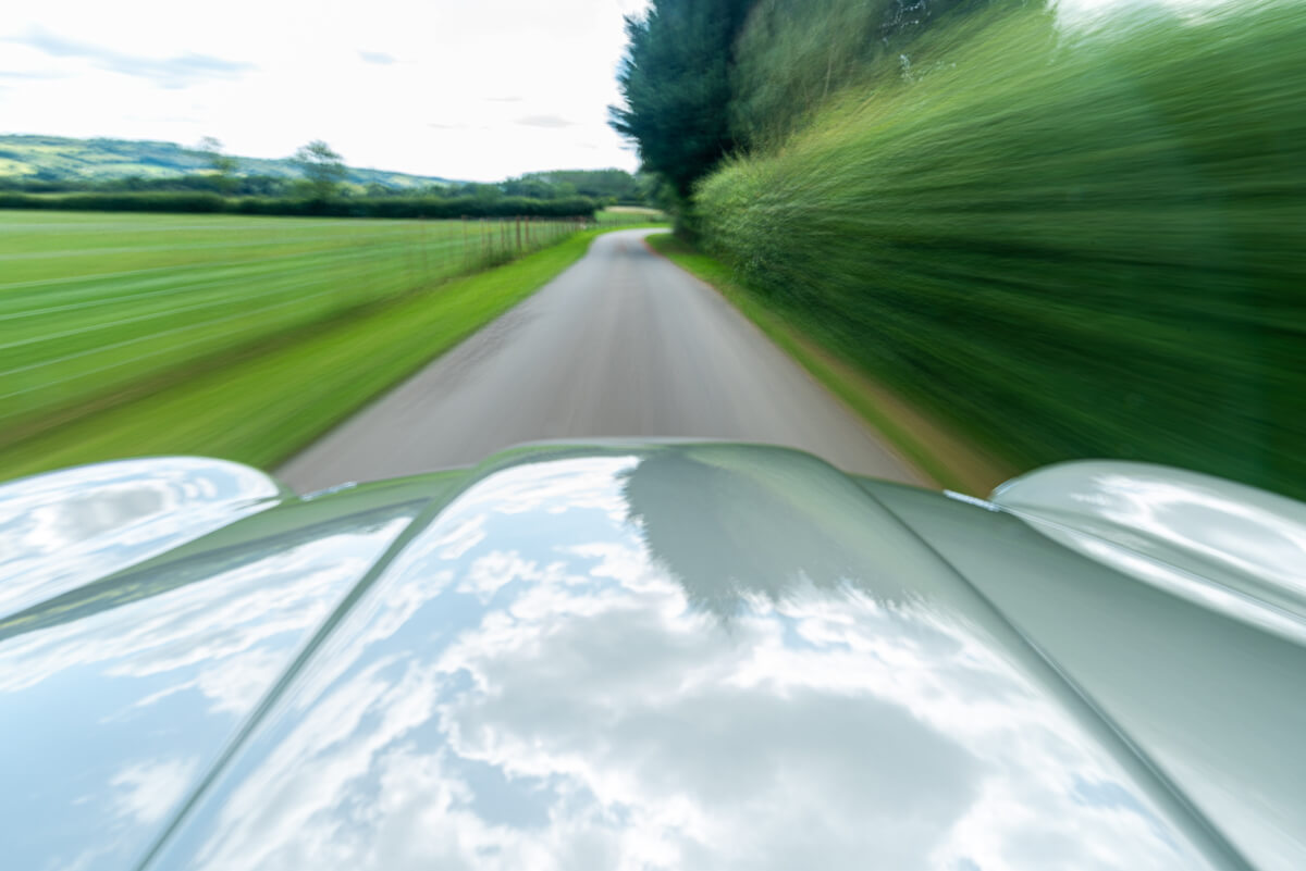 Aston Martin DB5 driving motion shot
